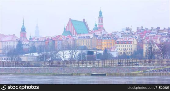 Panorama of Royal Castle and colorful houses by the Vistula River in Warsaw, Poland.. Old Town and river Vistula at night in Warsaw, Poland.