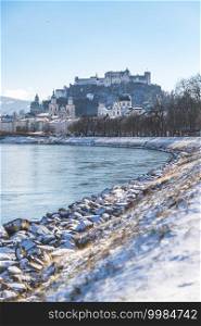 Panorama of Salzburg in winter, snow river bank, historical center, river Salzach