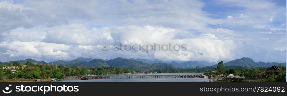 panorama of Sangklaburi. A wooden bridge over the river and raft accommodation for tourists.