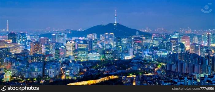 Panorama of Seoul downtown cityscape illuminated with lights and Namsan Seoul Tower in the evening view from Inwang mountain. Seoul, South Korea.. Seoul skyline in the night, South Korea.