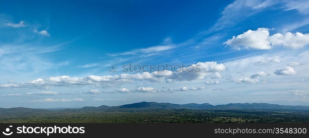 Panorama of sky above small mountains, covered with trees. Sri Lanka