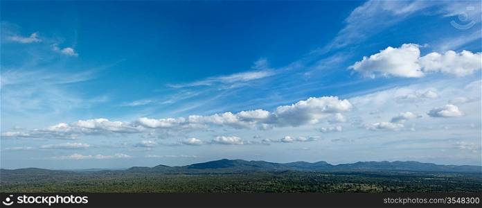 Panorama of sky above small mountains, covered with trees. Sri Lanka