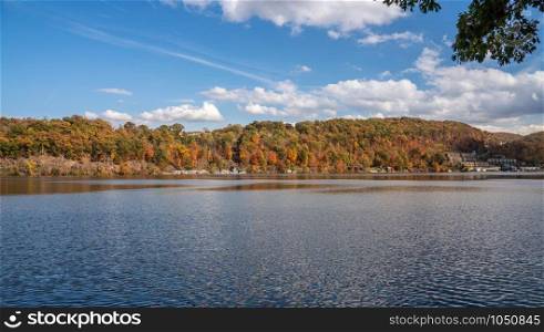 Panorama of the autumn fall colors surrounding Cheat Lake from the waterside near Morgantown, West Virginia. Fall colors on Cheat Lake in Morgantown West Virginia
