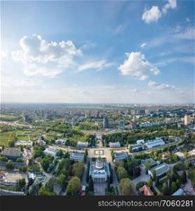 Panorama of the city of Kiev. National Exhibition Center with a park and pavilions on a sunny spring day against a blue sky with white clouds. Ukraine. Photo from the drone. Exhibition Center at Kiev, vdnh, panoramic view city ,Ukraine. Photo from the drone