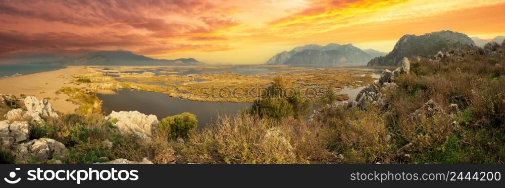 Panorama of the Dalyan river delta under dramatic sunset sky. Dalyan, Mugla, Turkey. Panorama of Dalyan river delta under dramatic sunset sky