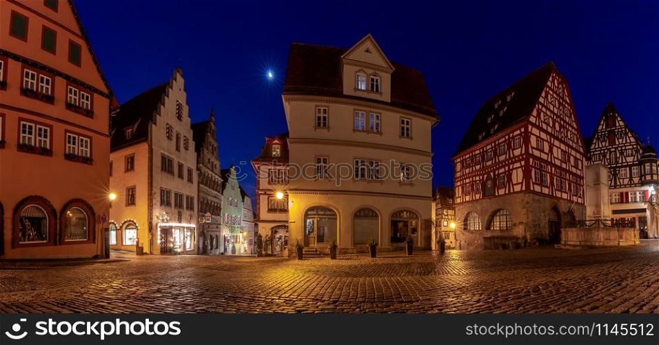 Panorama of the market square and the facades of medieval half-timbered houses. Rothenburg ob der Tauber. Bavaria Germany.. Rothenburg ob der Tauber. Panorama of the market square in night illumination.