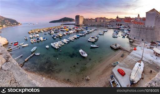 Panorama of the old medieval city harbor at sunset. Dubrovnik. Croatia.. Panoramic aerial view of Dubrovnik on a sunny morning.