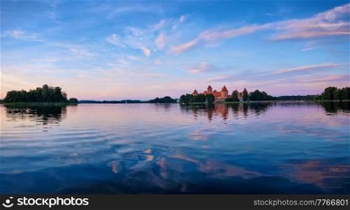 Panorama of Trakai Island Castle in lake Galve, Lithuania on sunset with dramatic sky reflecting in water. Trakai Castle is one of major tourist attractions of Lituania. Trakai Island Castle in lake Galve, Lithuania