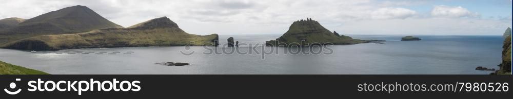 Panorama of Vagar, Gasholmur and Tindholmur on the Faroe Islands with salmon farm