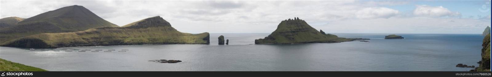 Panorama of Vagar, Gasholmur and Tindholmur on the Faroe Islands with salmon farm
