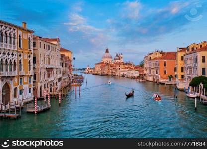 Panorama of Venice Grand Canal with boats and Santa Maria della Salute church on sunset from Ponte dell&rsquo;Accademia bridge. Venice, Italy. Panorama of Venice Grand Canal and Santa Maria della Salute church on sunset