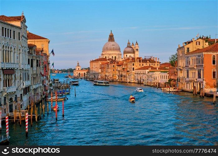 Panorama of Venice Grand Canal with gondola boats and Santa Maria della Salute church on sunset from Ponte dell&rsquo;Accademia bridge. Venice, Italy. Panorama of Venice Grand Canal and Santa Maria della Salute church on sunset