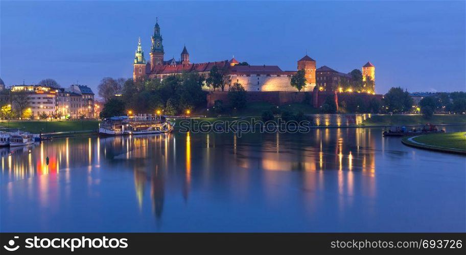 Panorama of Wawel Castle on Wawel Hill with reflection in the river at night as seen from the Vistula, Krakow, Poland. Night Wawel castle, Wroclaw, Poland