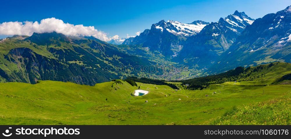 Panorama of Wetterhorn massif raised above the valley settlements of Grindelwald as seen from Klein Matterhorn, Switzerland. Grindelwald valley, Switzerland