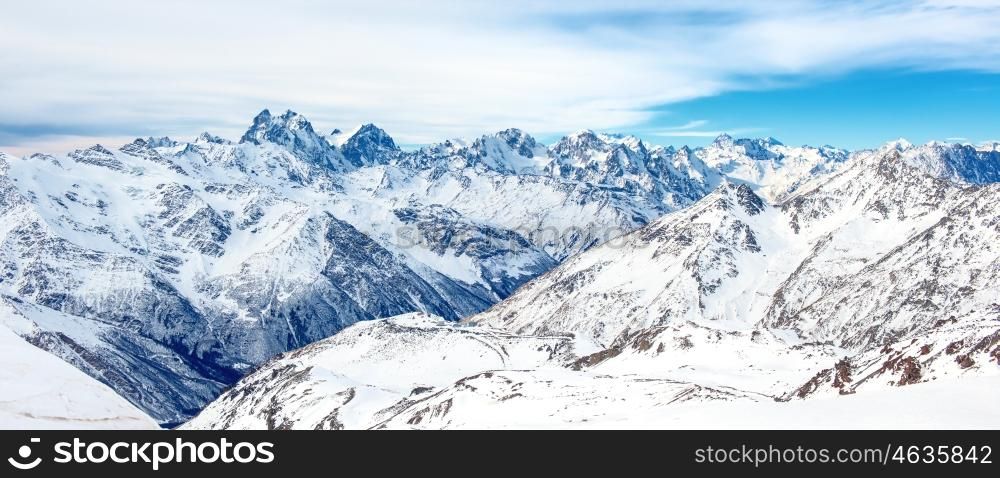 Panorama of winter mountains in snow. Landscape with high peaks
