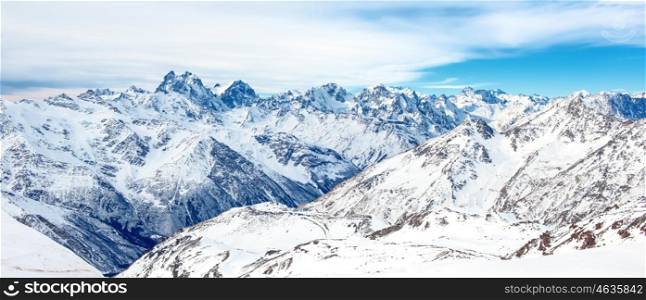 Panorama of winter mountains in snow. Landscape with high peaks
