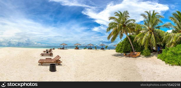 Panorama of Wooden sunbed on tropical beach in the Maldives at summer day