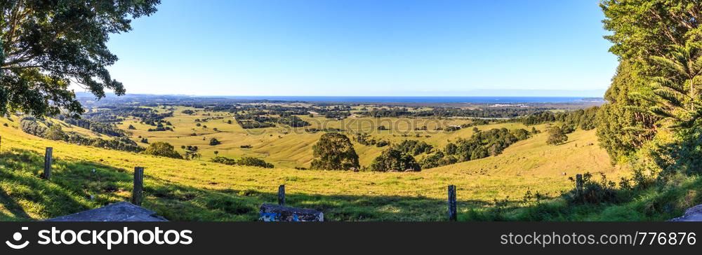 Panorama over rolling hills to the sea on a clear sunny day.