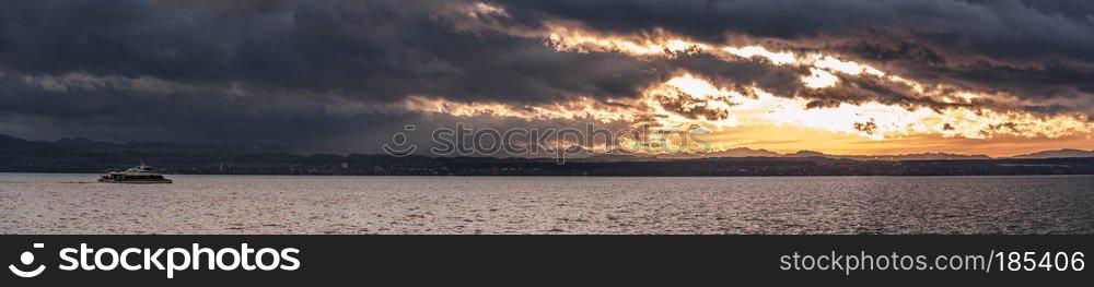 Panorama over the lake Bodensee at sunset on a cloudy day of november, in Friedrichshafen, Germany