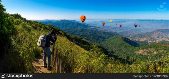 Panorama professional photographer take landscape photos by digital camera at topview on mountain