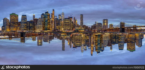 Panorama scene of New york Cityscape with Brooklyn Bridge beside the east river at the twilight time, Reflection with opposite concept, USA downtown skyline, Architecture and building with tourist concept