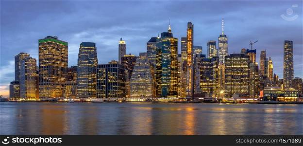 Panorama scene of New york Cityscape with Brooklyn Bridge beside the east river at the twilight time, USA downtown skyline, Architecture and building with tourist concept