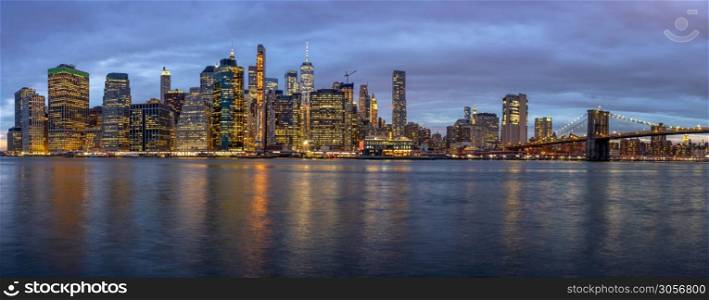 Panorama scene of New york Cityscape with Brooklyn Bridge beside the east river at the twilight time, USA downtown skyline, Architecture and building with tourist concept