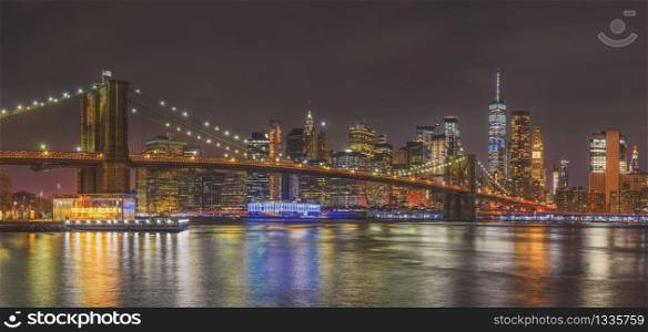Panorama scene of New york Cityscape with Brooklyn Bridge over the east river at the twilight time, USA downtown skyline, Architecture and building with tourist concept