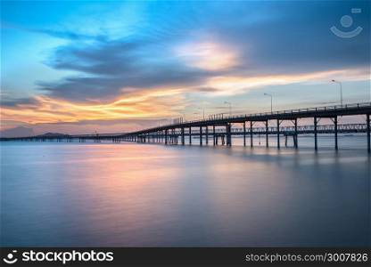 Panorama scene of transportation cargo bridge to seaport along twilight sky at beautiful