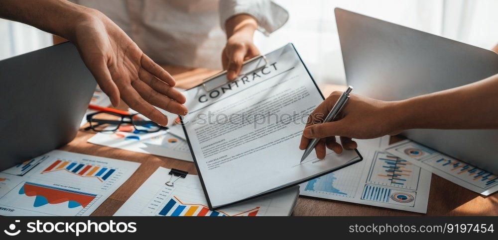 Panorama shot hand signing signature on legal contract, business report and BI Fintech paper on table. Seal business agreement deal with signature. Investment loan for startup company. Scrutinize. Panorama shot hand signing signature on legal contract. Scrutinize