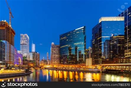 Panorama shot of City of Chicago downtown and Chicago River sunset night in Chicago Illinois USA.