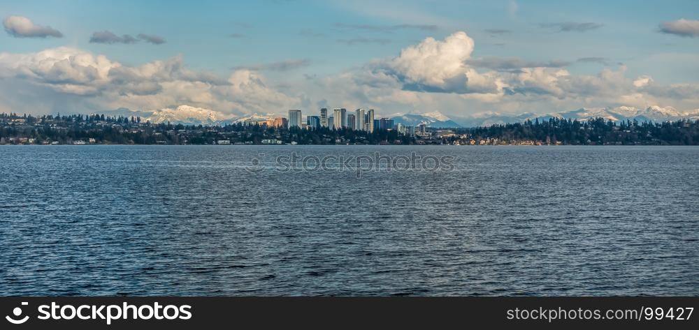 Panorama shot of the skyline of Bellevue, Washington with the Cascade Mountains behind.