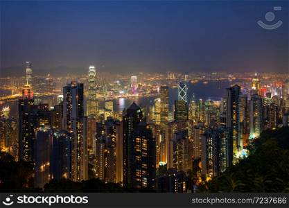 Panorama view of Hong Kong&rsquo;s illuminated skyline as seen from Victoria Peak at dusk.
