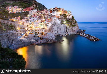 panorama view of Manarola village one of Cinque Terre at night in La Spezia, Italy