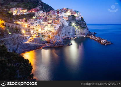 panorama view of Manarola village one of Cinque Terre at night in La Spezia, Italy