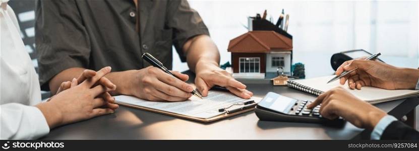 Panorama view of married couple signing house loan contract with real estate agent. Client customer purchasing new home, sealing the deal with signatures after reviewing terms and agreements. Prodigy. Panorama view of married couple signing house loan contract with broker. Prodigy