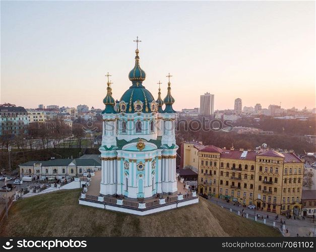 Panorama view of Podol and beautiful baroque St. Andrew&rsquo;s Church or the Cathedral of St. Andrew on sunset in Kyiv , Ukraine. Drone photo. aerial view of Podol and St Andrew&rsquo;s Church on the sunset in Kiev city