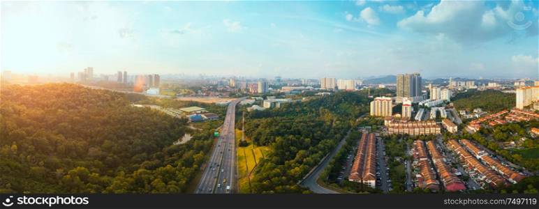 Panorama wide angle view cityscape,green park,terrace house and highway located at Kuala Lumpur,Malaysia .