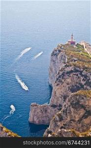 Panorama with Capri lighthouse and boats during a sunny day
