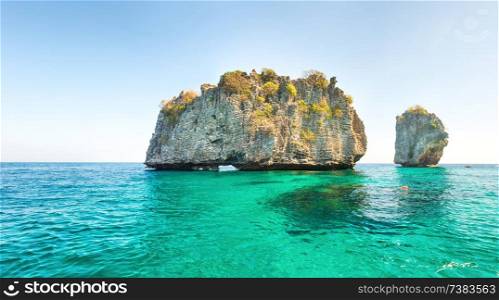 Panorama with landscape of beautiful rocky tropical island in blue sea. 