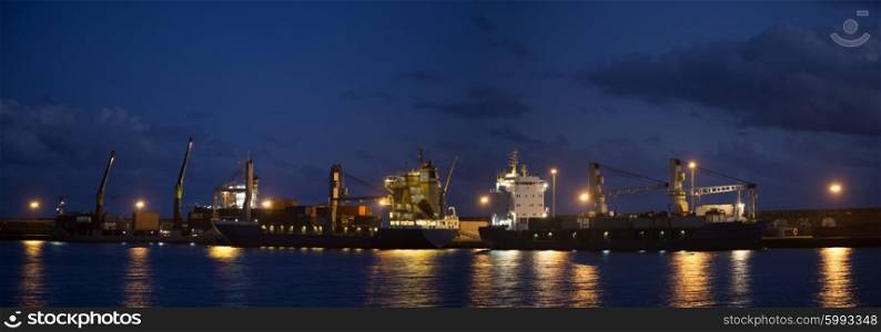Panorama with ships and cranes near night pier with illumination&#xA;