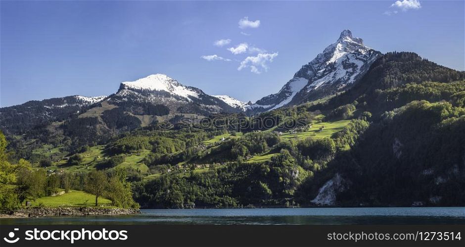 Panorama with swiss Alps peaks, near Walensee lake, in St. Gallen, Switzerland. Snowy mountain peaks, summer in swiss Alps.