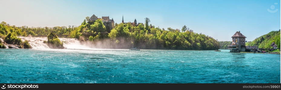 Panorama with the Rhienfall, the Laufen castle and Worth Castle, while boats navigate the blue waters of the river, in Switzerland.