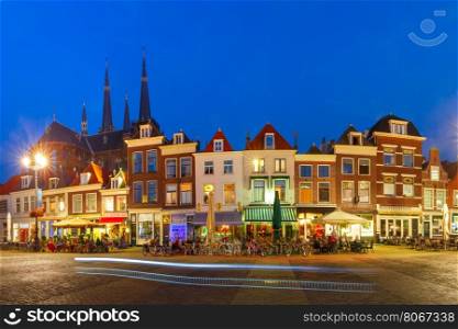 Panorama wiyh typical Dutch houses on the Markt square in the center of the old city at night, and Maria van Jessekerk on the background, Delft, Holland, Netherlands
