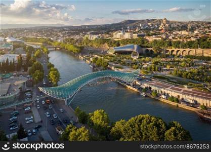 Panoramic aerial view of downtown Tbilisi, Georgia. In the foreground is the Peace Bridge over the Mtkvari River.