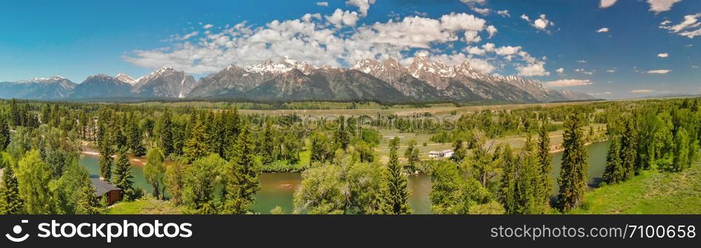 Panoramic aerial view of Grand Teton peaks, landscape and Snake River on a beautiful summer day, Wyoming - USA.