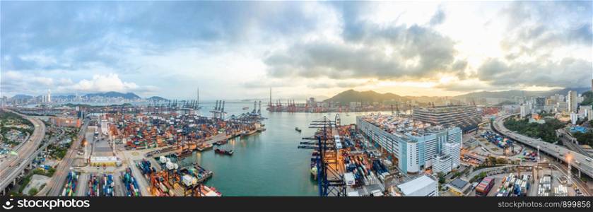 Panoramic aerial view of Hong Kong port industrial district, Stonecutters Bridge, and city on sunset skyline background. Logistic industry, Asia cityscape landscape, or transportation business concept