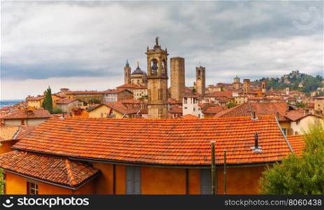 Panoramic aerial view of Medieval Upper town Citta alta of Bergamo with towers and churches in nasty cloydy day, Lombardy, Italy