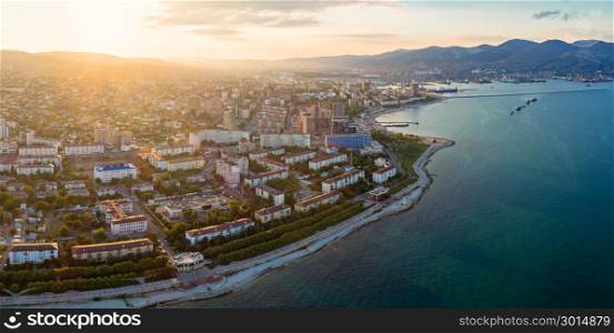 Panoramic aerial view of Novorossiysk seafront and port at sunset