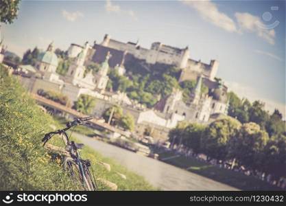 Panoramic city landscape of Salzburg in Summer, Bicycle in the foreground.